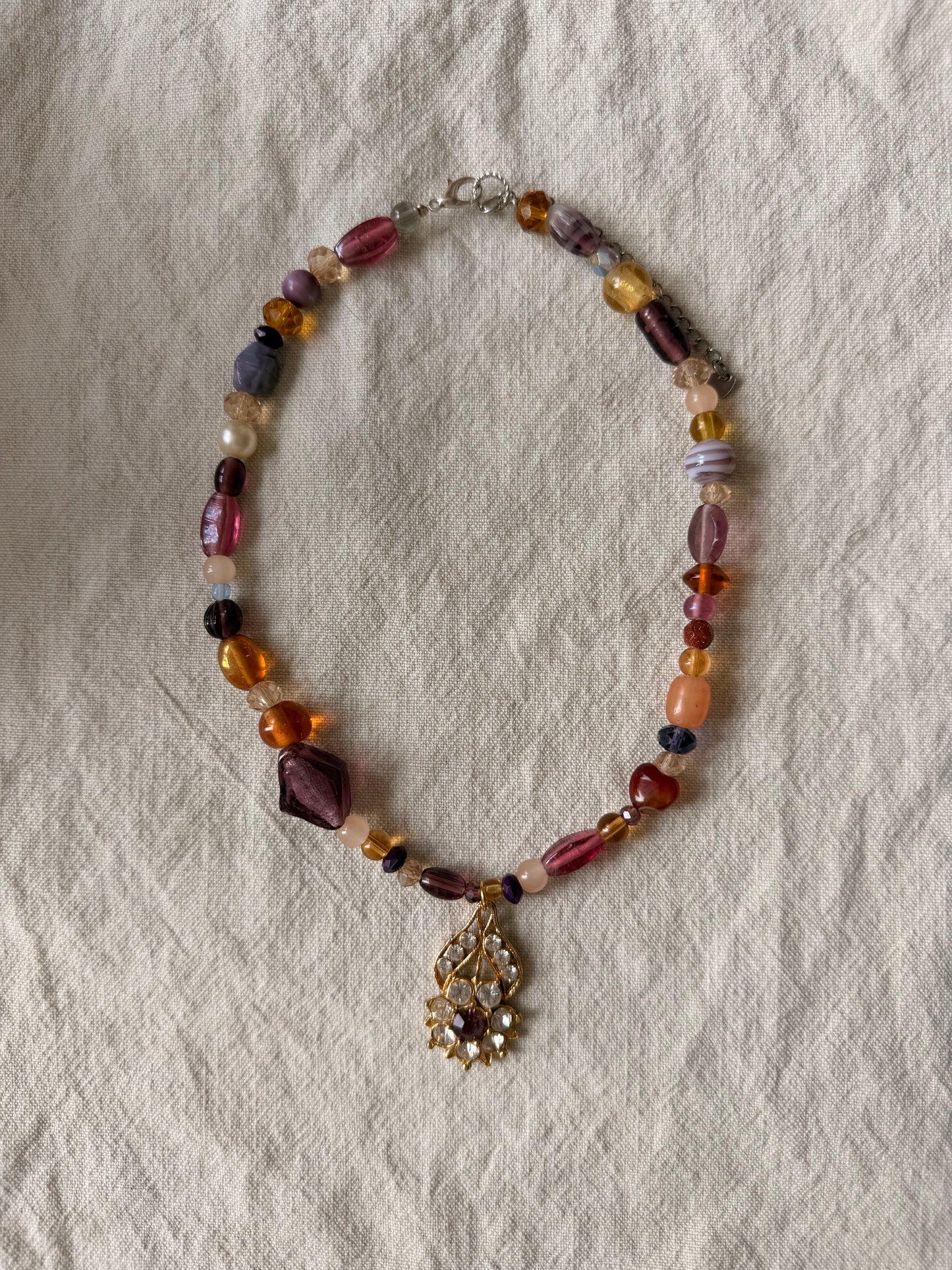 Upsidedown flower on purple beads